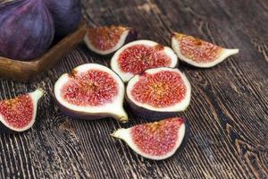 ripe purple figs on a wooden table photo