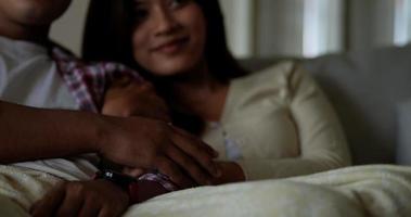 Selective focus, Close up scene, Male hands place on hand of his girlfriend while watching romantic movie on TV. video