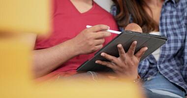 Selective focus, close up, Male hand use pencil checking on tablet while counting boxs after relocation in their new home, new house concept video