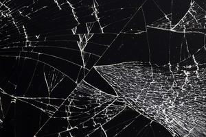broken thin glass with lots of cracks photo