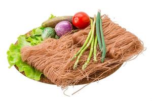 Raw rice noodles on white background photo