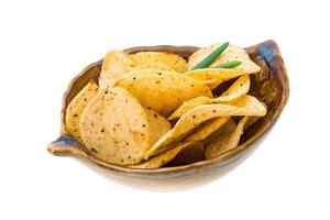 Potato chips in a bowl on white background photo