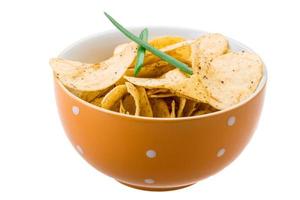 Potato chips in a bowl on white background photo