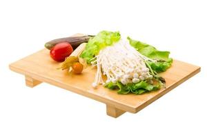 Japan mushroom on wooden plate and white background photo