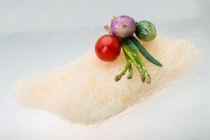 Raw rice noodles on white background photo