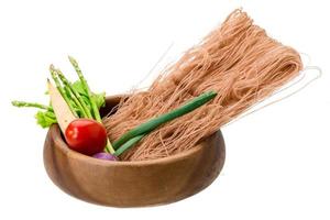 Raw rice noodles in a bowl on white background photo