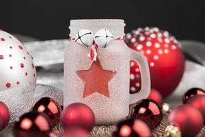 christmas candle in a glass jar and other decorations photo