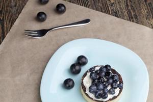 tartlet with chocolate and buttercream with blueberries photo