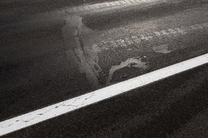 paved road, a close up of a part of the carriageway of an asphalt road photo