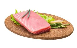 Tuna raw steak on wooden plate and white background photo