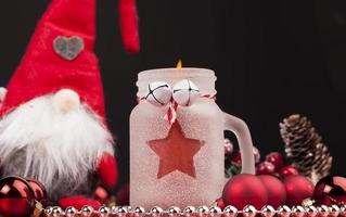 christmas candle in a glass jar and other decorations photo
