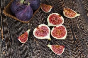 ripe purple figs on a wooden table photo