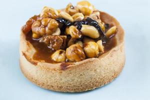 nut tartlet covered with a layer of liquid caramel photo