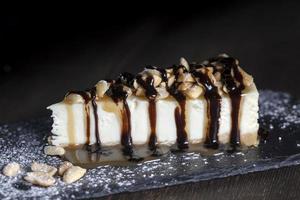 dessert cheesecake covered with caramel and chocolate photo