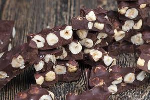 milk chocolate with whole and chunks of hazelnuts photo