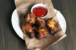 baked chicken wings together with ketchup photo