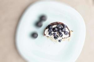 tartlet with chocolate and buttercream with blueberries photo