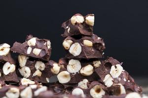 milk chocolate with whole and chunks of hazelnuts photo
