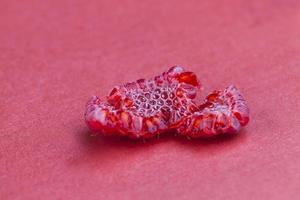 ripe red raspberries on red paper photo