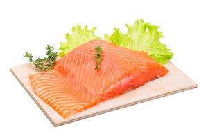 Salmon fillet on wooden plate and white background photo