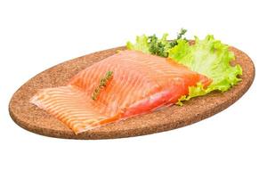 Salmon fillet on wooden plate and white background photo