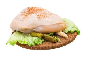 Chicken breast on wooden plate and white background photo