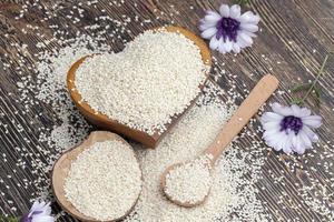 white sesame seeds on a wooden table photo