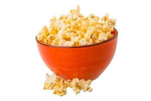 Popcorn in a bowl on white background photo