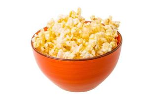 Popcorn in a bowl on white background photo