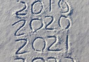 the inscription about the new year 2022 on the snow in winter photo