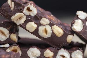 milk chocolate with whole and chunks of hazelnuts photo