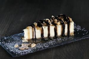 dessert cheesecake covered with caramel and chocolate photo