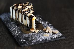 dessert cheesecake covered with caramel and chocolate photo