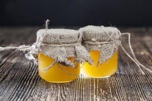 fresh bee honey packed in glass jars photo