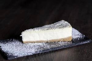 dessert cheesecake covered with dried coconut pulp photo