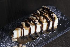 dessert cheesecake covered with caramel and chocolate photo