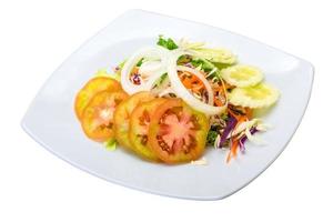 Vegetable salad on the plate and white background photo