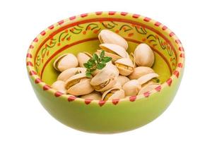 Pistachio in a bowl on white background photo