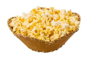 Popcorn in a basket on white background photo