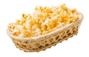 Popcorn in a basket on white background photo