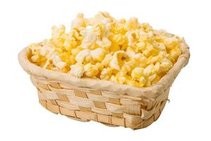 Popcorn in a basket on white background photo