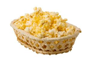 Popcorn in a basket on white background photo