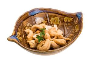 Cashew in a bowl on white background photo