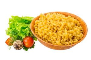 Fusilli pasta in a bowl on white background photo