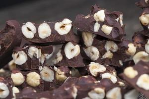 milk chocolate with whole and chunks of hazelnuts photo