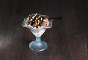 chocolate ice cream with peanuts, caramel and chocolate photo