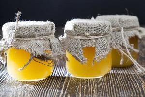 fresh bee honey packed in glass jars photo