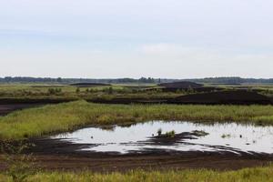 the flooded area where peat is extracted photo