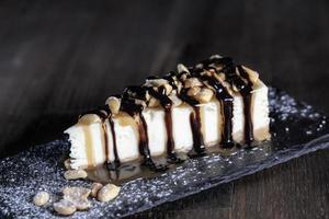 dessert cheesecake covered with caramel and chocolate photo