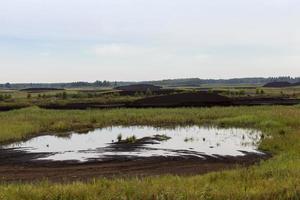 the flooded area where peat is extracted photo